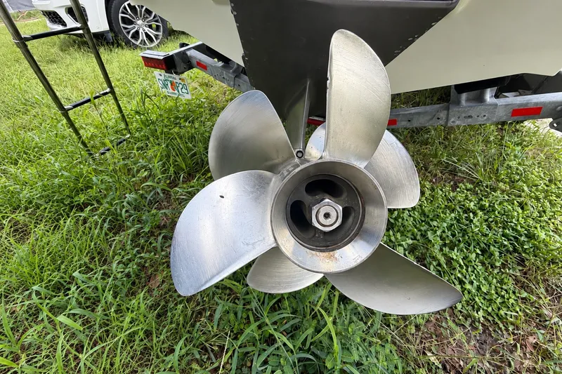 Slide: The Image of Propeller of a 2022 Regal LS2 boat on a trailer, surrounded by grass. - 54