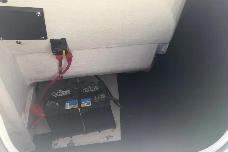 Slide: The Image of Battery compartment of a 2022 Regal LS2 boat with wiring connections. - 50