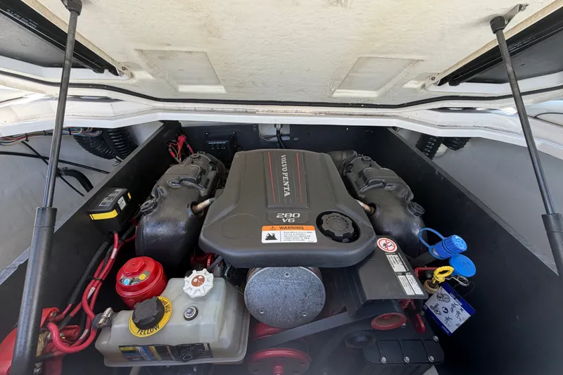 Slide: The Image of Engine compartment of a 2022 Regal LS2 boat featuring a Volvo Penta 280 V6 engine. - 61