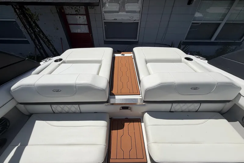 Slide: The Image of 2022 Regal LS2 boat interior with white seating and wooden accents. - 38