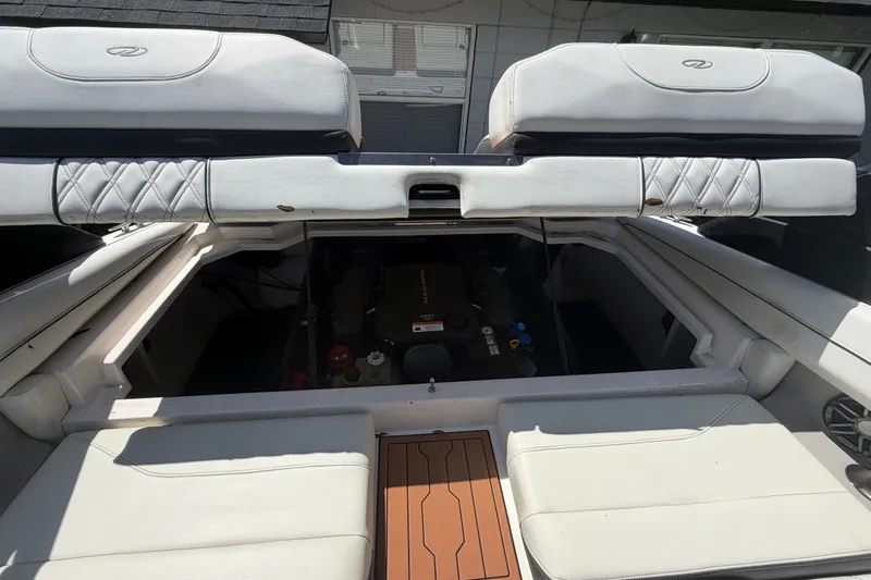 Slide: The Image of 2022 Regal LS2 boat engine compartment with open hatch, showcasing interior details. - 58