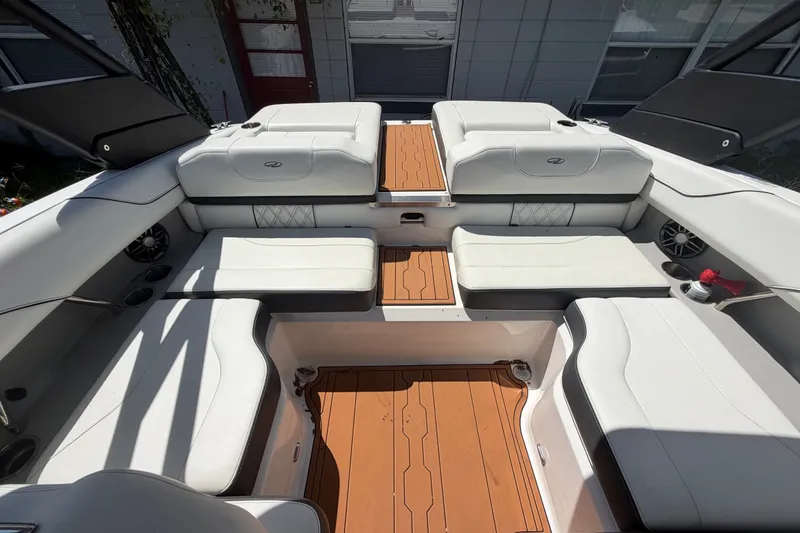 Slide: The Image of Luxurious 2022 Regal LS2 boat interior with white seating and teak flooring. - 37