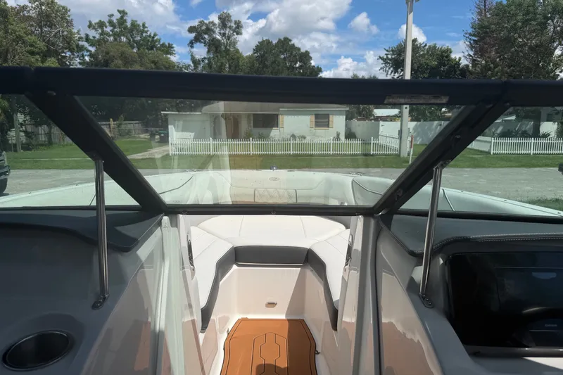Slide: The Image of 2022 Regal LS2 boat interior with open windshield, showcasing seating and dashboard. - 55