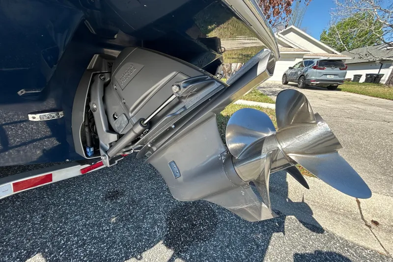 Slide: The Image of 2022 Regal LS2 boat propeller and outdrive on a trailer in a residential area. - 9