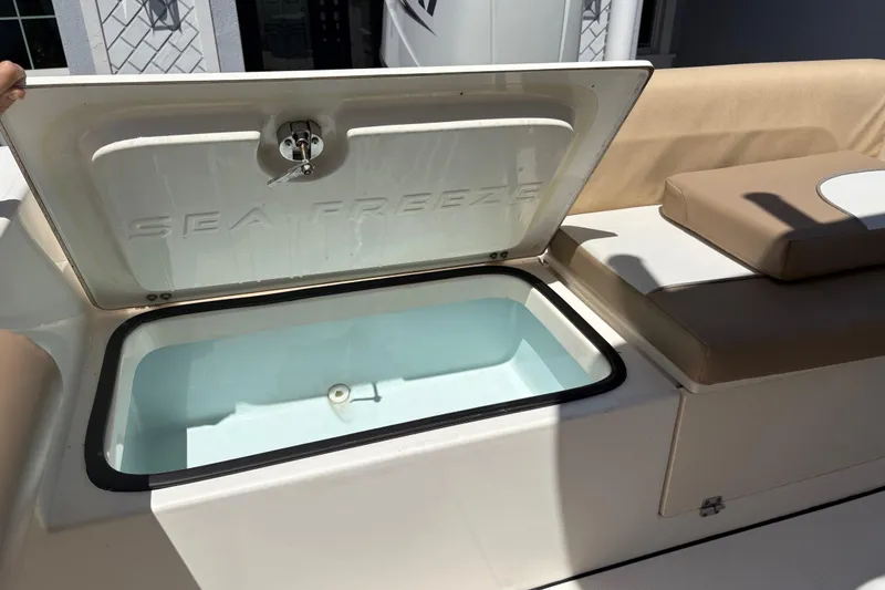 Slide: The Image of 2022 Sea Born LX22 Center Console with open storage compartment and cushioned seating. - 29