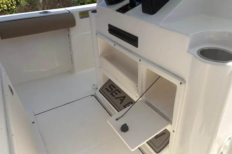 Slide: The Image of 2022 Sea Born LX22 Center Console interior with storage compartments and cup holder. - 27