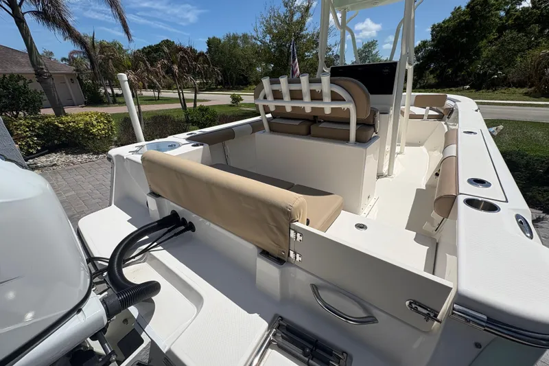 Slide: The Image of 2022 Sea Born LX22 Center Console boat with beige seating and rod holders. - 31