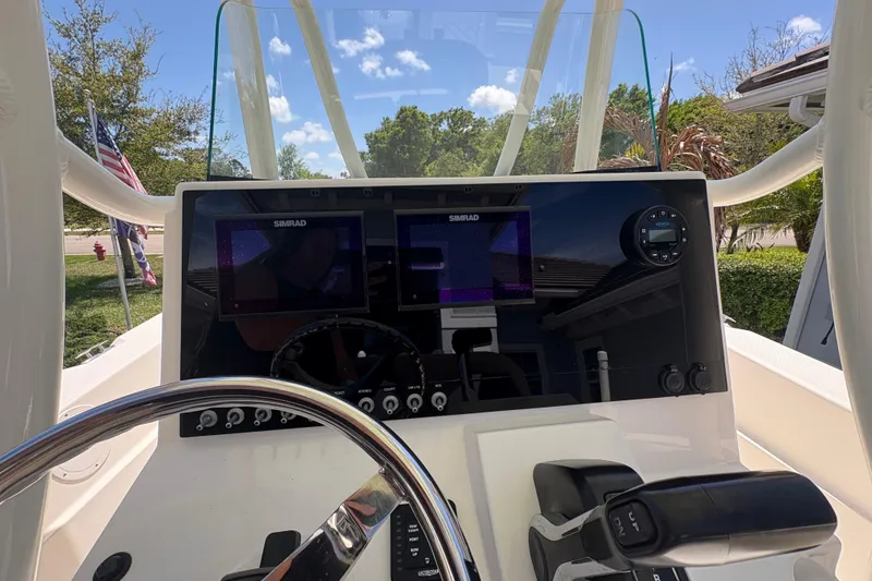 Slide: The Image of 2022 Sea Born LX22 Center Console dashboard with Simrad displays and steering wheel. - 17
