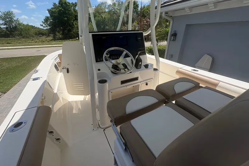 Slide: The Image of 2022 Sea Born LX22 Center Console boat interior with steering wheel and seating. - 22