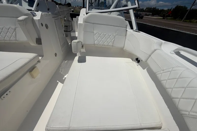 Slide: The Image of 2023 Edgewater 248CX Crossover boat interior with white cushioned seating. - 71