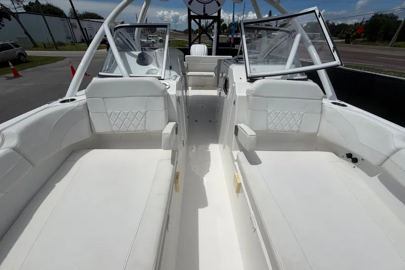Slide: The Image of 2023 Edgewater 248CX Crossover boat interior with white seating and open cockpit design. - 68