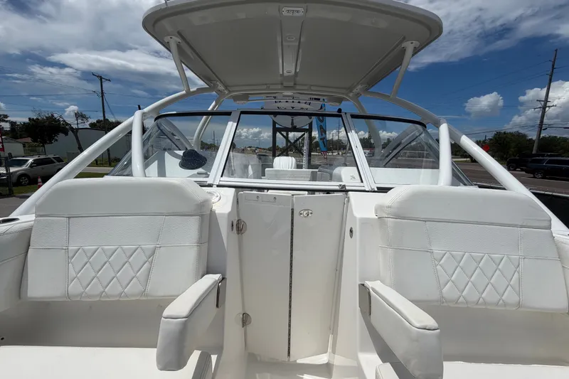Slide: The Image of 2023 Edgewater 248CX Crossover boat interior with white seating and open cockpit. - 74