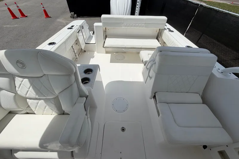 Slide: The Image of 2023 Edgewater 248CX Crossover boat interior with luxurious white seating and cup holders. - 77