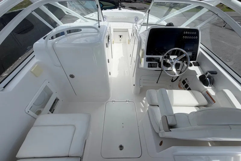 Slide: The Image of 2023 Edgewater 248CX Crossover boat interior with modern helm and seating. - 27