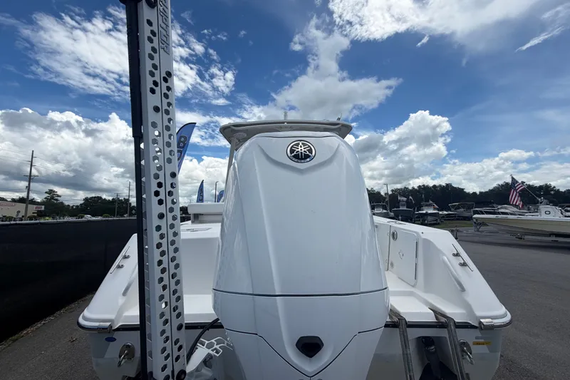 Slide: The Image of 2023 Edgewater 248CX Crossover boat with Yamaha engine under a cloudy sky. - 3