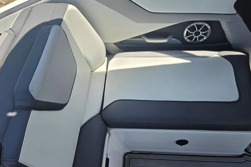 Slide: The Image of 2022 Yamaha Boats 252SD interior seating with sleek design and integrated speaker. - 23