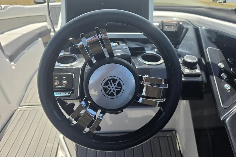 Slide: The Image of 2022 Yamaha Boats 252SD steering wheel and dashboard controls. - 39