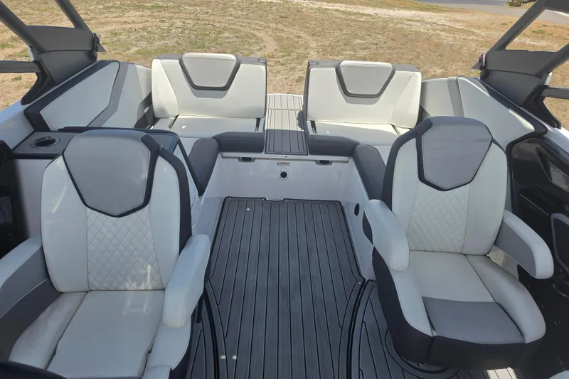 Slide: The Image of 2022 Yamaha Boats 252SD interior with luxurious seating and sleek design. - 76