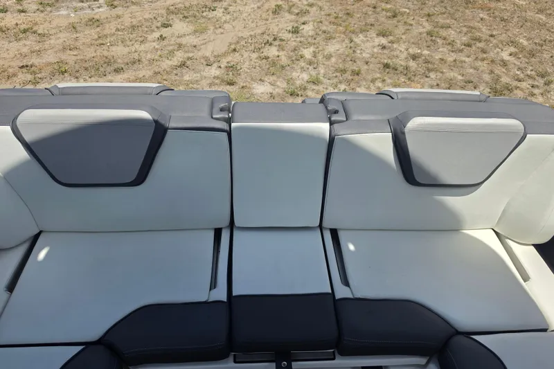 Slide: The Image of 2022 Yamaha Boats 252SD interior seating, featuring sleek gray and white upholstery. - 88