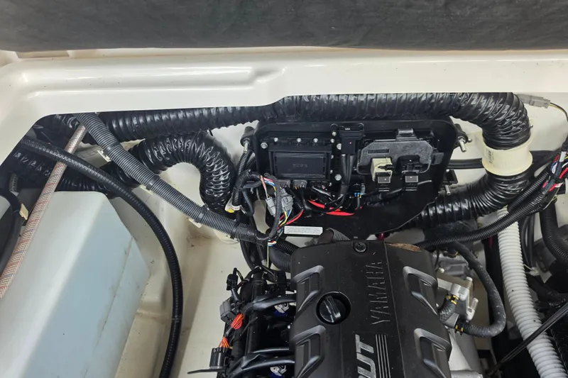 Slide: The Image of Engine compartment of a 2022 Yamaha Boats 252SD, showcasing wiring and components. - 90