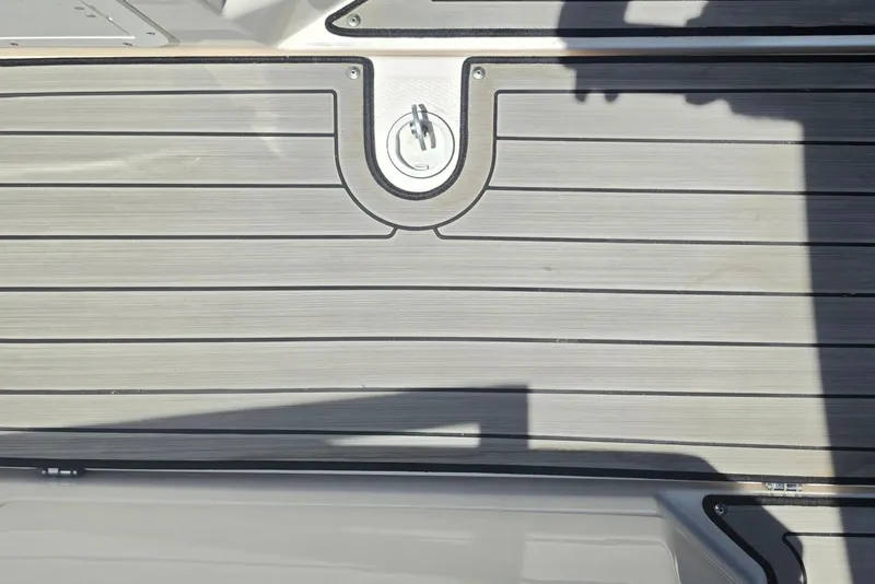 Slide: The Image of Deck of 2022 Yamaha Boats 252SD with non-slip surface and person wearing green shoes. - 85