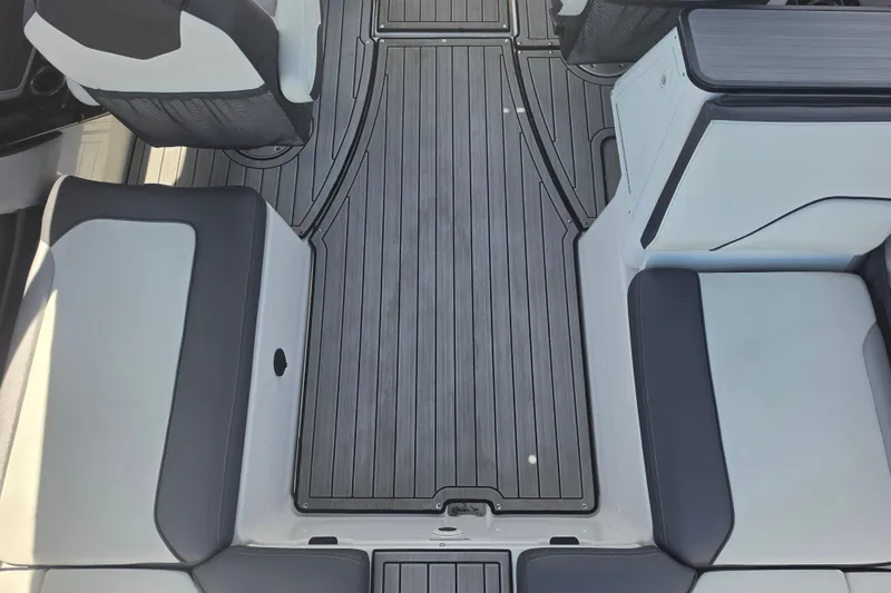 Slide: The Image of 2022 Yamaha Boats 252SD interior with sleek seating and modern flooring design. - 22