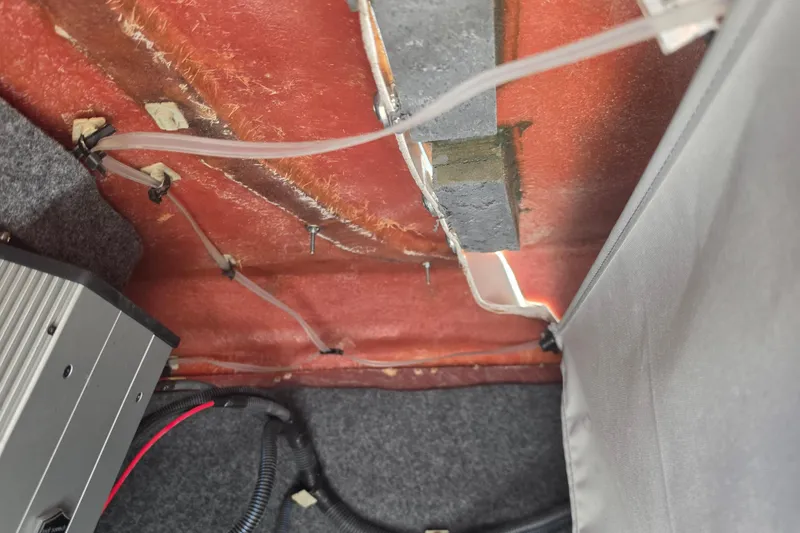 Slide: The Image of Interior view of a 2022 Yamaha Boats 252SD, showing wiring and components. - 52