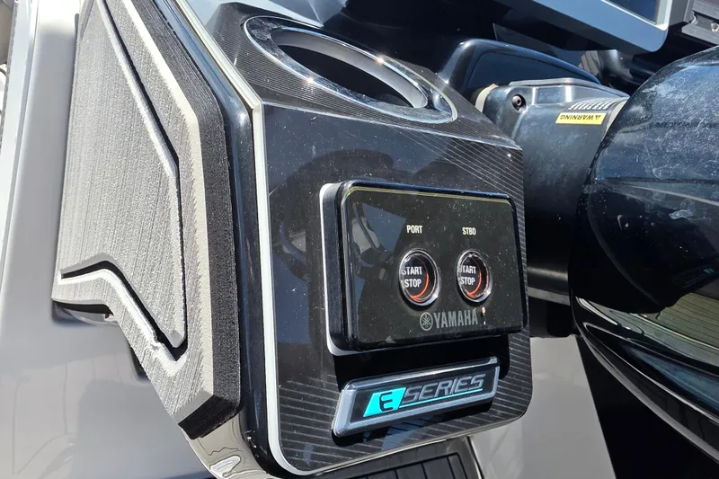 Slide: The Image of Control panel of 2022 Yamaha Boats 252SD, featuring start/stop buttons and cup holder. - 42