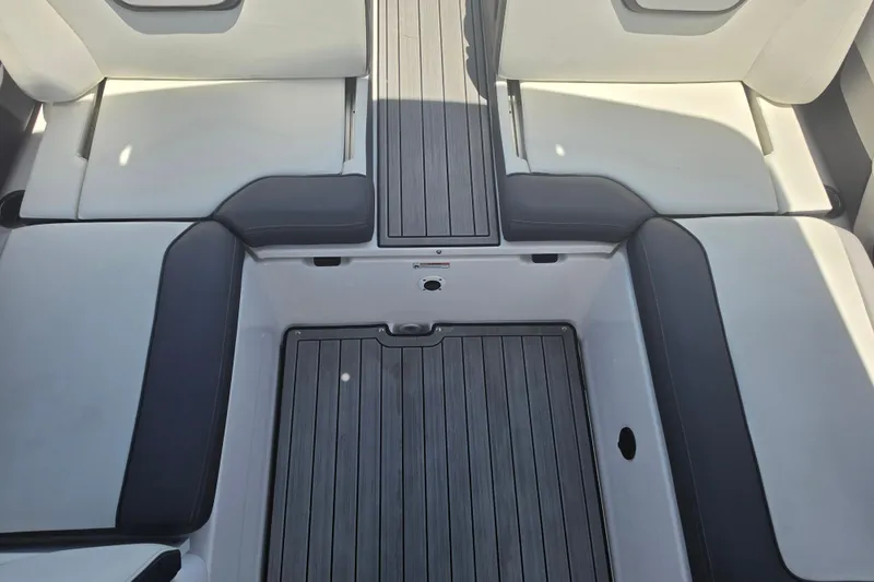 Slide: The Image of 2022 Yamaha Boats 252SD interior seating with sleek, modern design and comfortable cushions. - 73