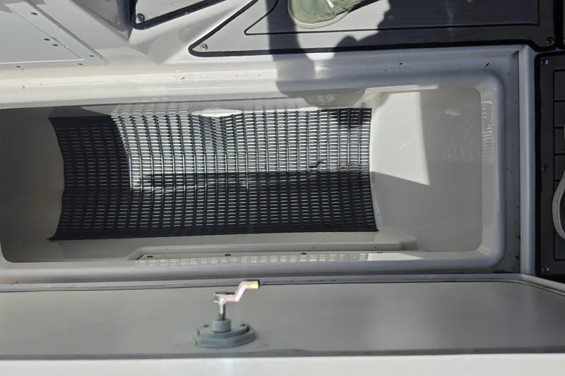 Slide: The Image of Storage compartment on a 2022 Yamaha Boats 252SD, featuring a textured interior. - 86