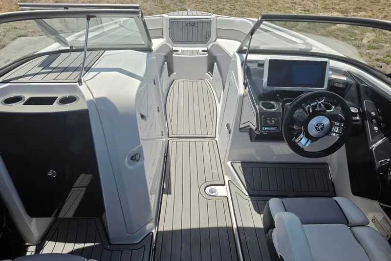Slide: The Image of 2022 Yamaha Boats 252SD interior with sleek dashboard and modern steering wheel design. - 31