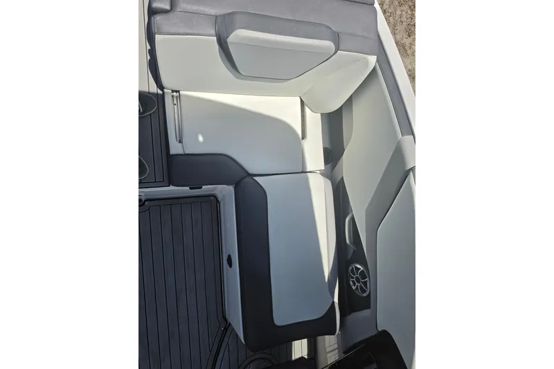 Slide: The Image of 2022 Yamaha Boats 252SD interior seating with sleek, modern design and integrated speaker. - 69