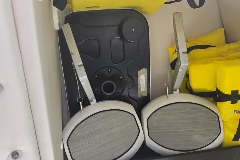 Slide: The Image of Storage compartment of 2022 Yamaha Boats 252SD with life jackets and accessories. - 50