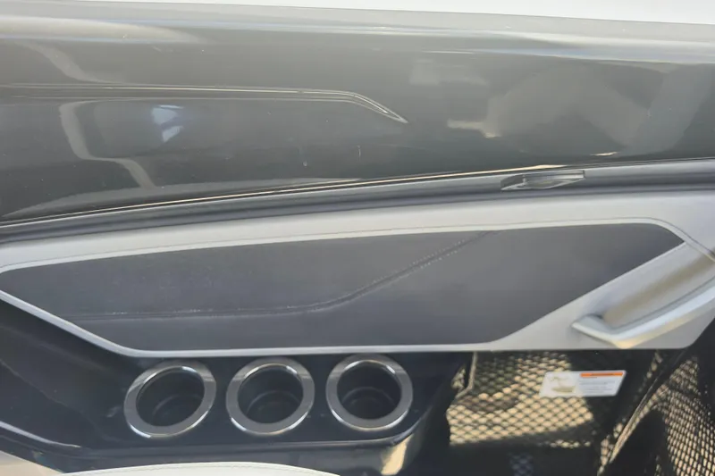 Slide: The Image of Interior detail of 2022 Yamaha Boats 252SD, featuring sleek design and cup holders. - 35