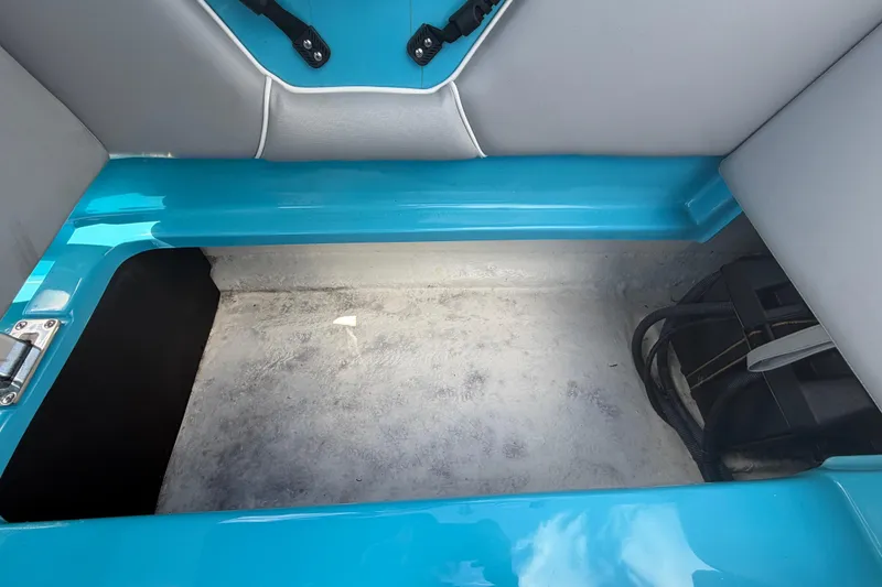 Slide: The Image of 2023 Heyday WTSurf boat storage compartment with blue trim and battery. - 29