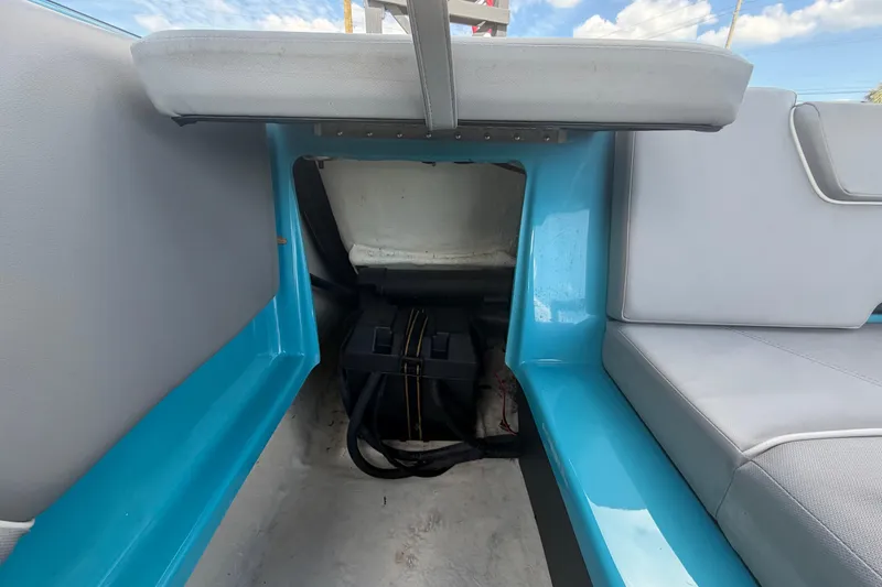 Slide: The Image of 2023 Heyday WTSurf boat interior storage compartment with blue and gray seating. - 30