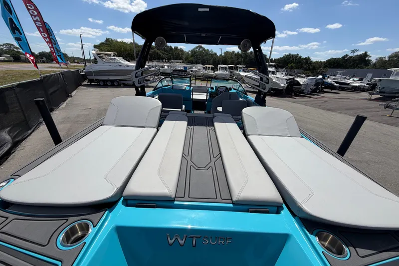Slide: The Image of 2023 Heyday WTSurf boat with sleek seating and modern design at a marina. - 50