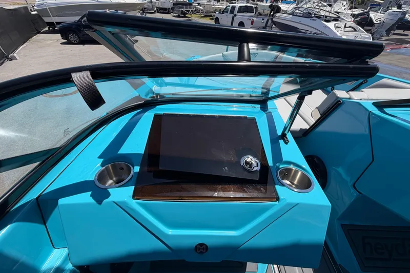 Slide: The Image of 2023 Heyday WTSurf boat interior with blue dashboard and cup holders. - 73