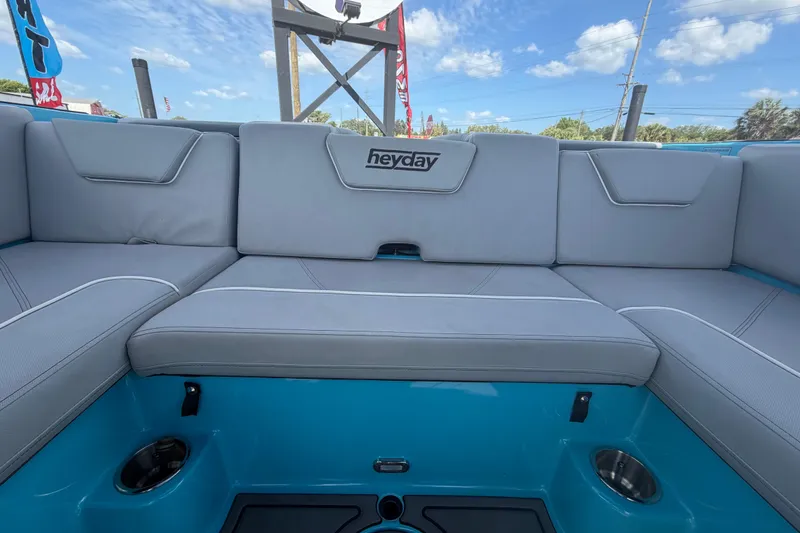 Slide: The Image of 2023 Heyday WTSurf boat interior with gray seating and cup holders. - 31