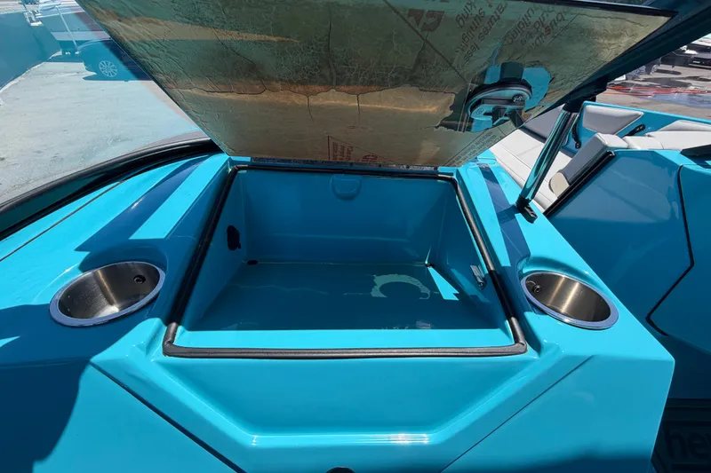Slide: The Image of Open storage compartment on 2023 Heyday WTSurf boat with cup holders. - 74