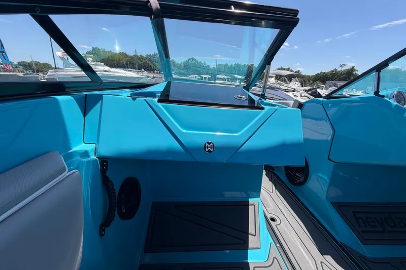 Slide: The Image of 2023 Heyday WTSurf boat interior with vibrant blue dashboard and seating. - 72