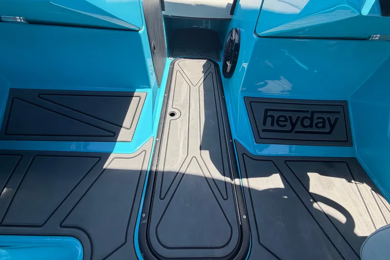 Slide: The Image of 2023 Heyday WTSurf boat interior with blue and black flooring design. - 76