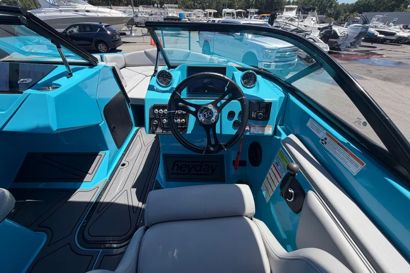 Slide: The Image of 2023 Heyday WTSurf boat interior with blue dashboard and steering wheel. - 63