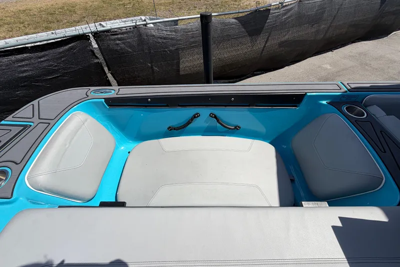 Slide: The Image of 2023 Heyday WTSurf boat interior with blue and gray seating and cup holders. - 52