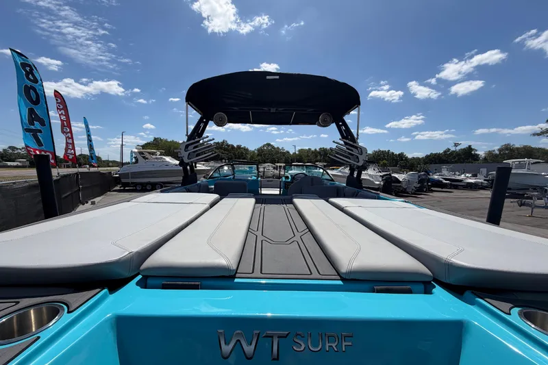 Slide: The Image of 2023 Heyday WTSurf boat with sleek design, showcased outdoors under a clear sky. - 57