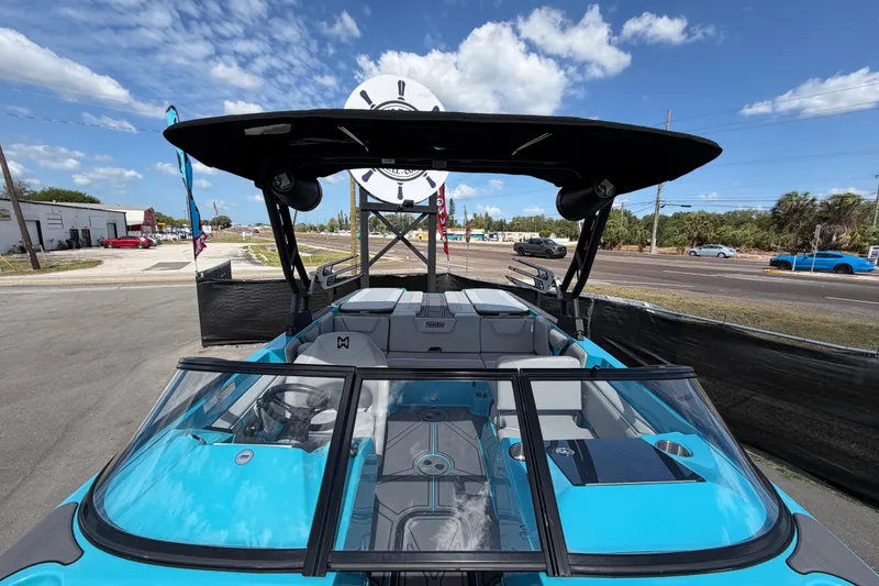 Slide: The Image of 2023 Heyday WTSurf boat with sleek design, blue exterior, and spacious interior under sunny skies. - 22