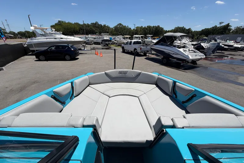 Slide: The Image of 2023 Heyday WTSurf boat with spacious seating, parked in a marina under a clear sky. - 82