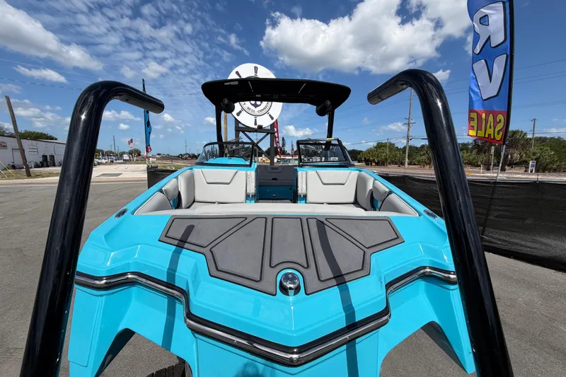 Slide: The Image of 2023 Heyday WTSurf boat in vibrant blue, showcased outdoors under a clear sky. - 14