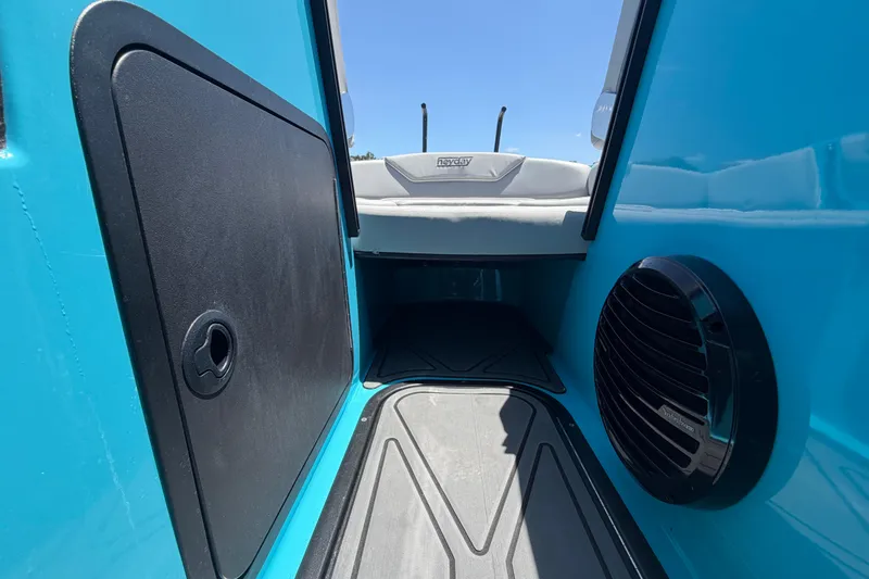 Slide: The Image of Interior view of a 2023 Heyday WTSurf boat, featuring blue panels and a speaker. - 79