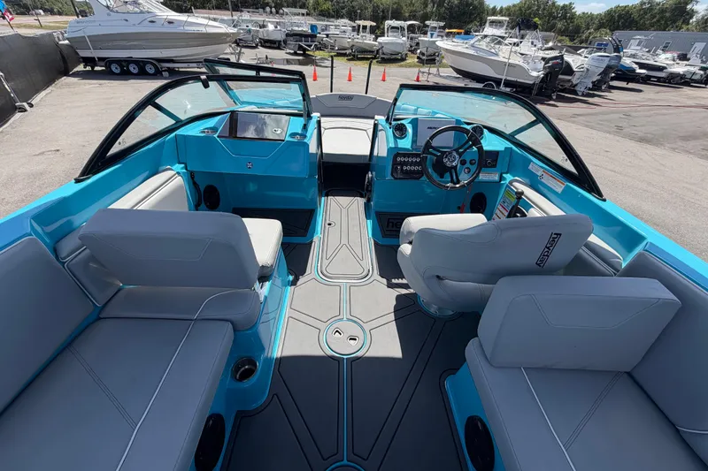 Slide: The Image of 2023 Heyday WTSurf boat interior with blue accents and modern seating. - 60